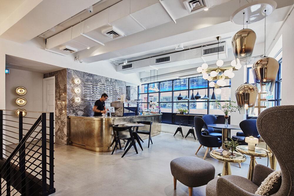 Stylish modern café interior with designer lighting and seating in Hong Kong by Tom Dixon