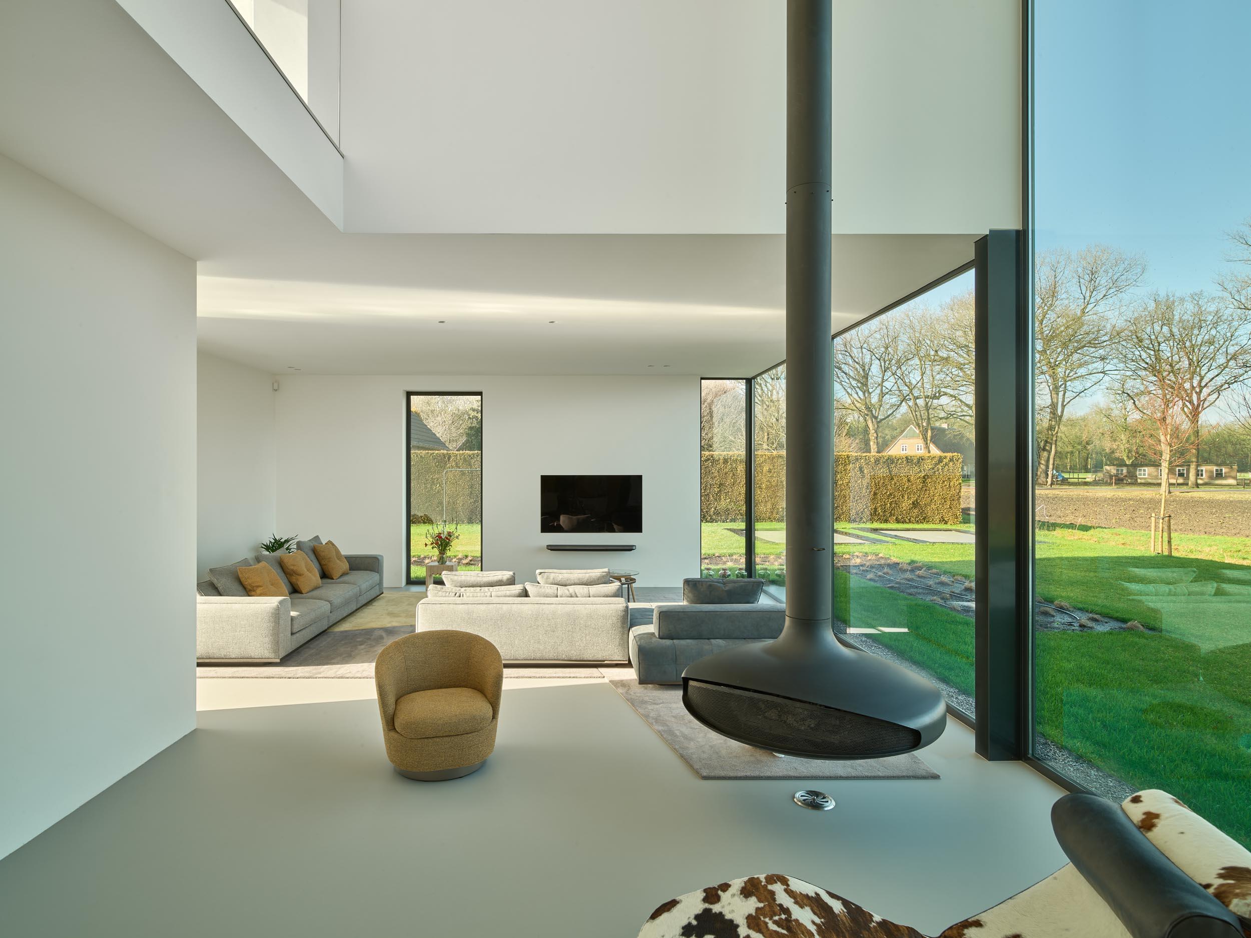 Modern living room with large glass windows and minimalistic interior design