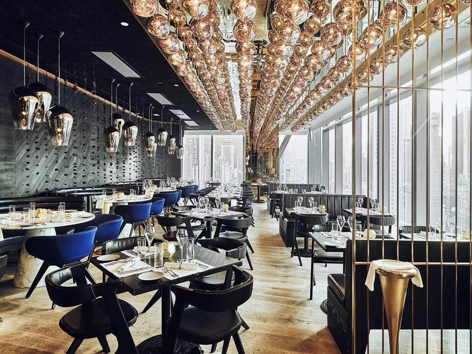 Contemporary restaurant interior with decorative ceiling lights and wooden floor